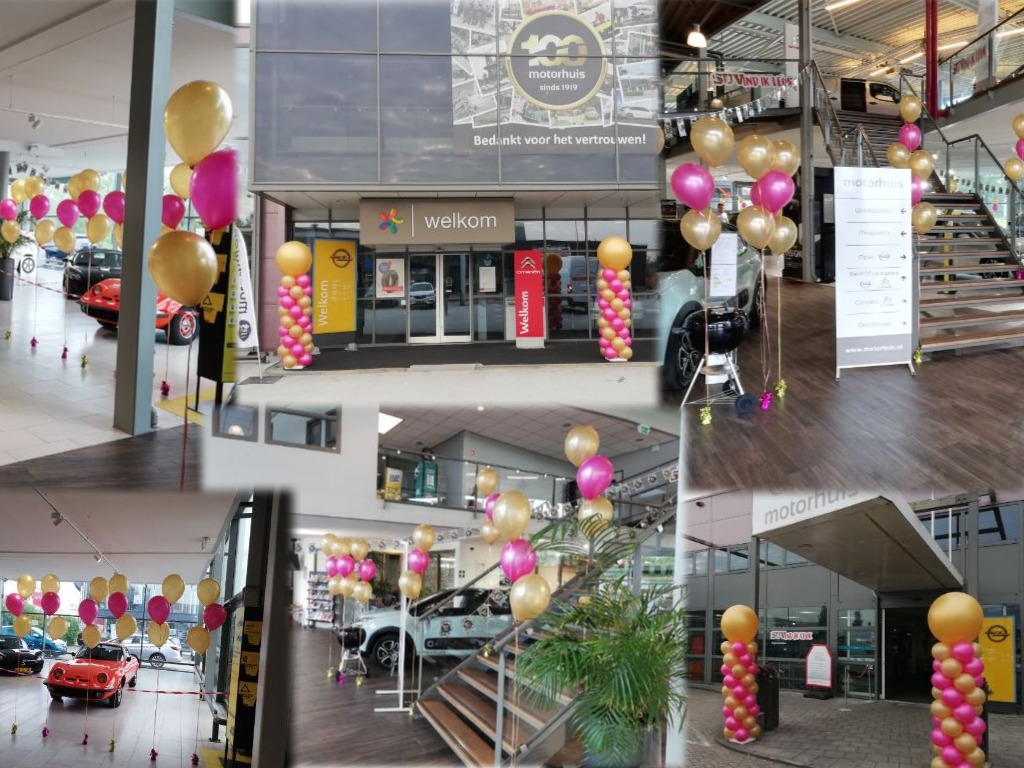 100 jaar jubileum motorhuis ballondecoraties pilaren helium trossen goud met roze ballonnen